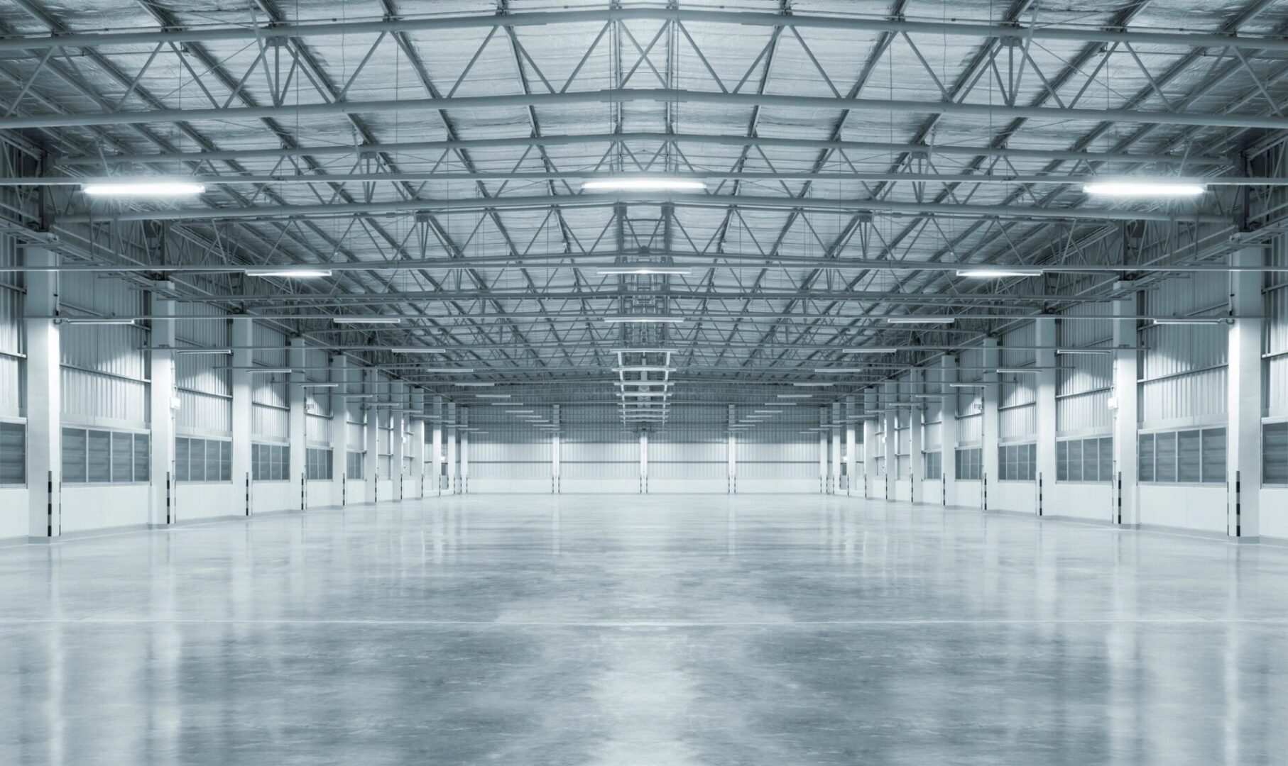 A large empty warehouse with lots of lights.